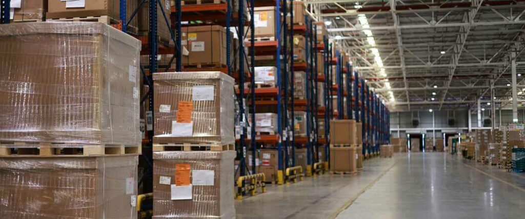 Palletized goods stacked on shelves in a warehouse.