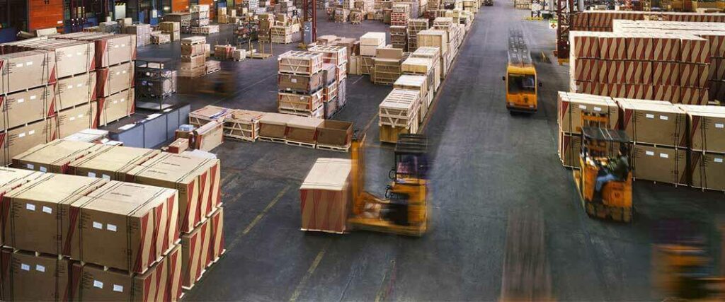 Pallet jacks in a warehouse moving palletized loads around